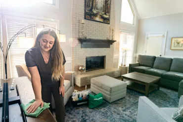 merry maid dusting living room furniture